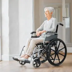 Elderly woman sitting in wheelchair.