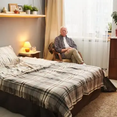 Cozy bedroom with a bed and chair.